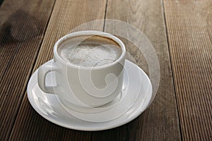 Coffee cup top view on wooden table background. Beautiful morning, outdiir, spring sun light