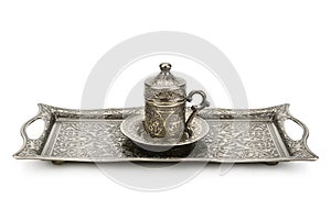 Coffee cup and tray with arabic decoration with metal cup and dish on a white background