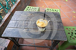 Coffee cup on vintage wooden table. Hot milk coffee