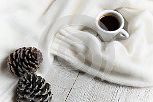 Coffee cup with warm cashmere sweater with pine cones