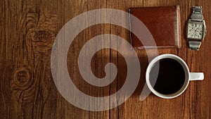 Coffee cup, watch, Wallet top view on wooden table background