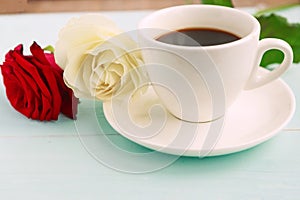 Coffee cup and white and red roses