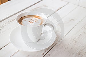 Coffee in a cup on a white wooden table