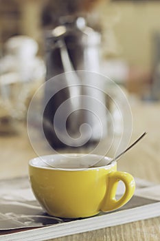 Coffee cup on wood table in cafe.