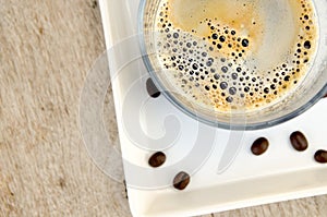 Coffee cup on wood table with coffee bean