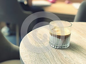 Coffee cup on wood table in coffee shop, stock photo