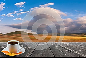 Coffee cup on wood table and view of beautiful nature background