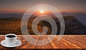 Coffee cup on wood table and view of beautiful nature background