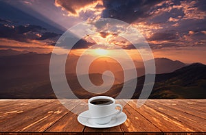 Coffee cup on wood table and view of beautiful nature background