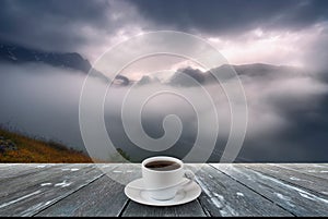 Coffee cup on wood table and view of beautiful nature background