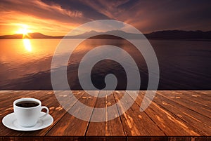 Coffee cup on wood table and view of beautiful nature background