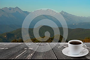 Coffee cup on wood table and view of beautiful nature background