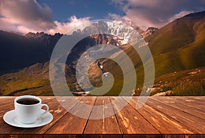 Coffee cup on wood table and view of beautiful nature background