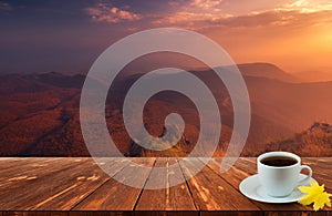 Coffee cup on wood table and view of beautiful nature background