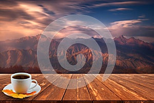 Coffee cup on wood table and view of beautiful nature background