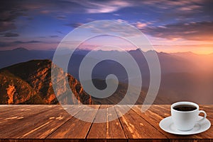 Coffee cup on wood table and view of beautiful nature background