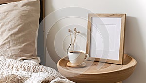 coffee cup and wooden photo frame on bedside table in bedroom