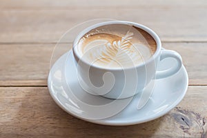 Coffee in a cup on a wooden table horizontal