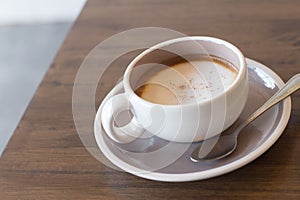 Coffee in a cup on a wooden table horizontal