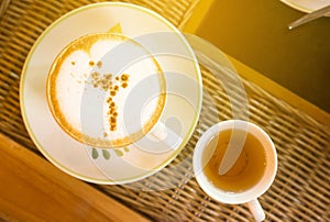 Coffee cup on wooden table,Latte art vintage color toned,Top view with copy space for text