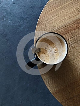 Coffee in a cup on wooden table. Top view.