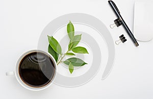 Coffee cup work space with computer mouse,paperclip and nice pen on white background,top view