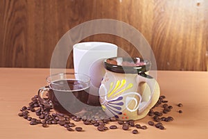 Coffee cups with coffee beans on the table photo