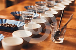 Coffee cups and beans on table ready for a tasting