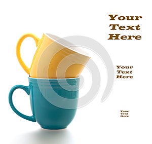 Coffee Cups in Blue and Yellow on White Background with Copyspace