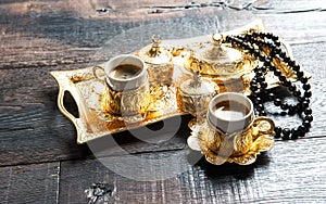 Coffee cups golden decorations rosary Oriental hospitality photo