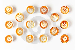 Coffee cups with latte art on white background, top view on white background