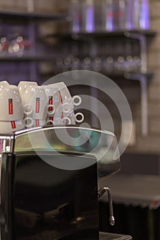 Coffee cups stacked up a machine
