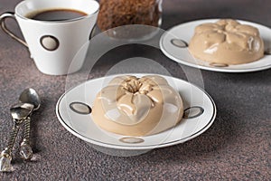 Coffee dessert made from cream and gelatin in portion molds on a brown background. Dessert Blancmange
