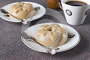 Coffee dessert made from cream and gelatin in portion molds on a brown background. Dessert Blancmange