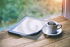 coffee and digital tablet on wooden table