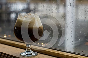 Coffee drink against rainy window