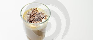 Coffee drink shot with a nutty note with fluffy milk foam, decorated with chocolate shavings