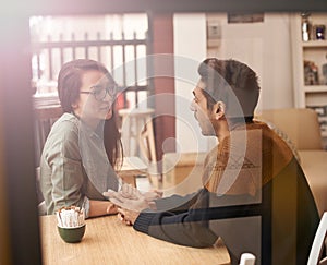 Coffee drinkers make better lovers. a young couple sitting in a coffee shop on a date.