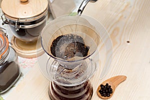 Coffee drip from steaming filter drip style on the table. Making brewed arabica coffee from steaming drip style.