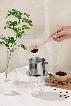 Coffee dripping in vietnamese style on wooden table