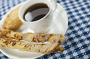 Coffee with empanada and cheese sticks