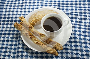 Coffee with empanada and cheese sticks photo