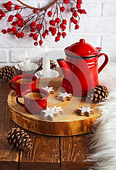 Coffee in enameled red cups and a red coffee pot