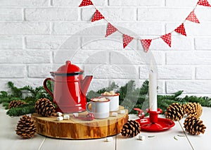 Coffee in enameled white cups and a red coffee pot