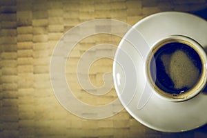 Coffee Espresso on a white plate and wooden background photo