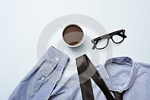 Coffee, eyeglasses, tie and shirt