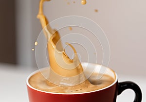 Coffee and foam splashing out of mug