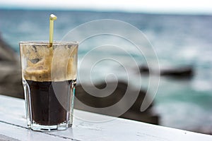 Coffee Frappe Fredo Iced with sea background photo