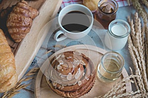 Coffee and fresh breads served for breakfast on wooden trays