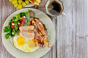 Coffee with fried eggs, bacon and salad fpr breakfast